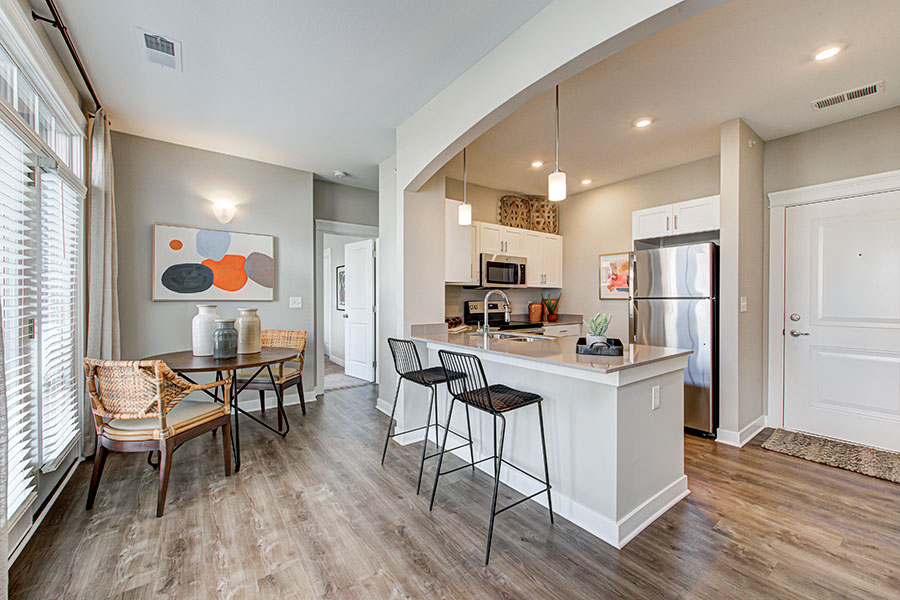 A real estate agent can help you find a nice place like this unit. Dining area and kitchen in upscale apartment.