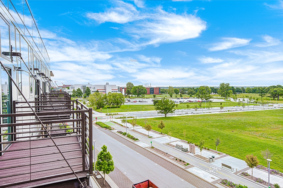 If you live in an apartment, a sunny balcony like these at Continuum Apartments is all you need to start a garden. A row of top-story apartment balconies and the view beyond