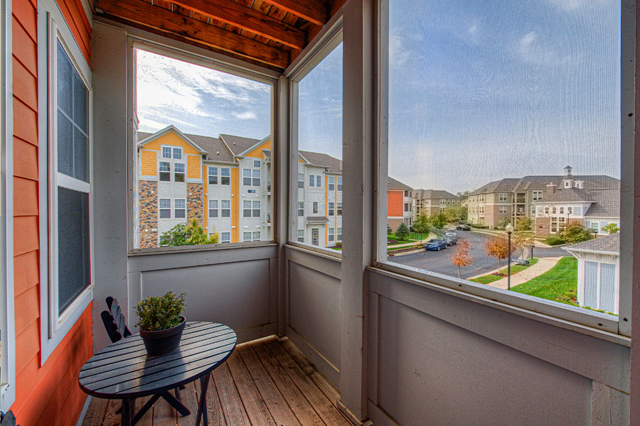 Enclosed balcony with a beautiful view of other apartment complexes.