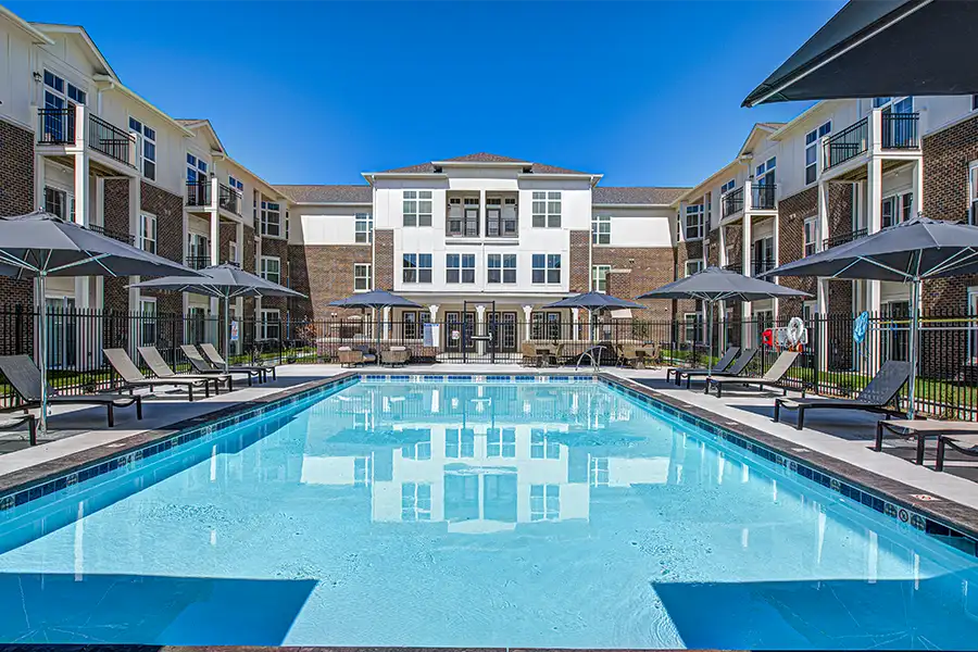Not sure what a community means by amenities? This pool at StoneBridge Apartments is one example of an amenity. Pristine pool surrounded by apartment buildings at StoneBridge Apartments.